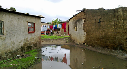 During rainy season this area is flooded, roads are full of ditches with muddy water and pit toilets are flooded with rain water, in Lusaka, Zambia © Sustainable Sanitation Alliance